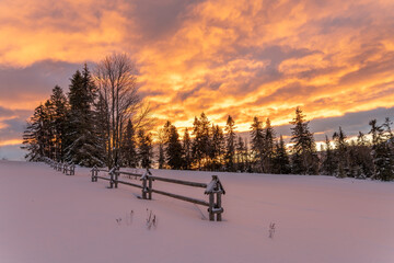 Wall Mural - a fiery, dramatic sunrise in a winter mountain scenery