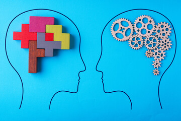 Human brain is made gear mechanism and colourful shapes on blue background. Two different thought processes.