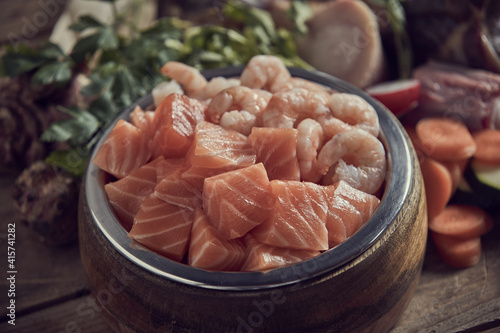 Appetizing raw salmon and shrimps in bowl in kitchen © exclusive-design