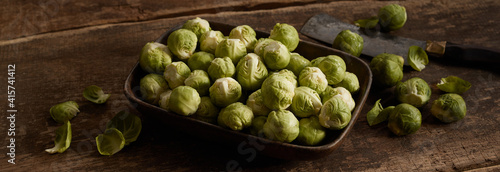 Cleaver and Brussel sprouts on timber table © exclusive-design