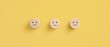 © Worawut - Wooden blocks with the happy face smile face symbol on yellow background, evaluation, Increase rating, Customer experience, satisfaction and best excellent services rating concept