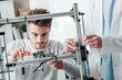 © StockPhotoPro - Engineers in the lab using a 3D printer