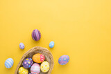 Fototapeta Desenie - Happy Easter day decoration colorful eggs in nest on paper background with copy space