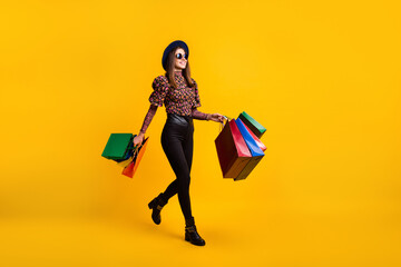 Canvas Print - Full length body size side profile photo of girl walking from shopping center with bags on sale isolated on bright yellow color background