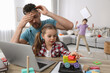 © New Africa - Children disturbing stressed man in living room. Working from home during quarantine