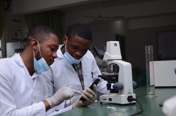 two handsome african doctor feeling excited about what they saw on their cellphone