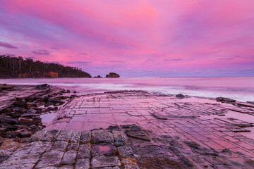 Beautiful sunset over the Tessellated Pavement . A rare geological phenomena . At Eaglehawk  Neck, South Eastern Tasmania, Australia.