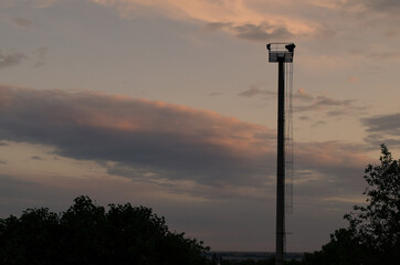  A solitary pillar against the backdrop of clouds illuminated by the sunset
