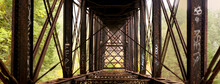 Looking Down The Underside Of An Old Rusty Rail Bridge