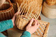 Man Weaving Wicker Basket Indoors, Closeup View