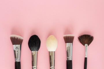 Poster - Set of large cosmetic brushes on pink background