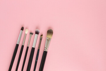 Wall Mural - Set of large cosmetic brushes on pink background