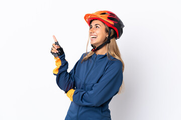 Wall Mural - Young hispanic cyclist woman isolated on white background pointing up a great idea