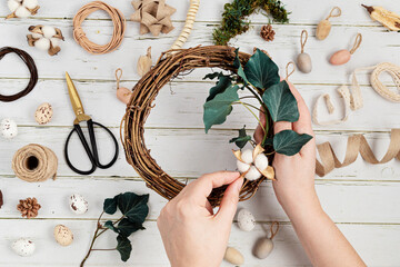 Handmade diy home decoration wreath with easter eggs and natural elements. Zero waste concept