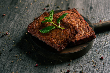 Wall Mural - cooked tofu fillets in a round wooden tray