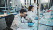 © Gorodenkoff - Medical Science Laboratory: Row of Diverse Team of Multi-Ethnic Young Scientists Looking Under Microscope, Analyze Chemicals, Talk, Solving Problems. Biotechnology Specialists working in Advanced Lab