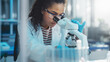 Medical Science Laboratory: Portrait of Beautiful Black Scientist Looking Under Microscope Does Analysis of Test Sample. Ambitious Young Biotechnology Specialist, working with Advanced Equipment