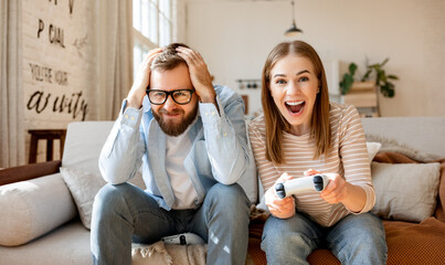 Wall Mural - Anxious man watching woman playing videogame