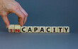 © Dzmitry - Capacity or incapacity symbol. Businessman turns wooden cubes and changes the word 'incapacity' to 'capacity'. Beautiful grey background. Business and capacity or incapacity concept. Copy space.