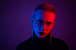 © Михаил Решетников - Portrait of a beautiful young woman with short hair in neon light. Displeased girl posing