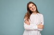 © Ivan Traimak - Young attractive brunette female person with sincere emotions isolated on background wall with copy space wearing casual white shirt. Happy concept