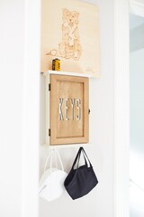 Small and beautiful wood box to store the house keys with two hanging masks.