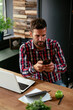 © JustLife - Businessman in office using the phone. Young businessman working in the office..