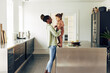 © Flamingo Images - Smiling mom standing with her cute little girl in their kitchen