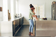 © Flamingo Images - Mom reading a story to her little girl in their kitchen