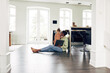 © Flamingo Images - Smiling mother and daughter watching something on a laptop at home