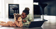 © Flamingo Images - Little girl watching something on a laptop with her mom