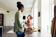 © Flamingo Images - Mom and her cute little daughter eating fruit at home