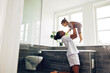 © Flamingo Images - Young mom holding her little girl in their bathroom at home