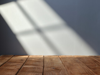 Empty table top for product presentation with wall in background and light from window