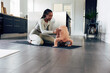 © Flamingo Images - Young mom playing with her little girl on an exercise mat