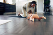 © Flamingo Images - Laughing mom playing with her little girl on an exercise mat