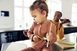 © Flamingo Images - Mom working from home and taking care of her little daughter