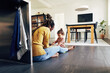 © Flamingo Images - Mom looking after her daughter while working on her kitchen floor