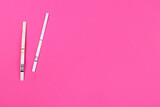Fototapeta  - positive and negative pregnancy test on a pink background