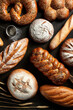 Assortment of baked goods on a dark background isometric, balance. Baked goods - golden rustic crusts of bread and buns on black chalkboard background.