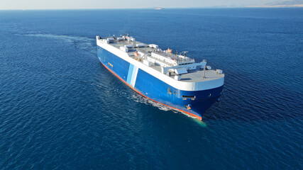 Aerial drone photo of huge car carrier ship RO-RO (Roll on Roll off) cruising in Mediterranean deep blue Aegean sea