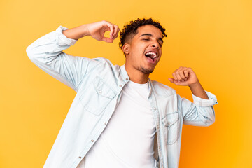 Young african american curly man isolated on purple celebrating a special day, jumps and raise arms with energy.