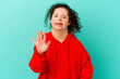 © Asier - Woman with Down syndrome isolated smiling cheerful showing number five with fingers.