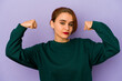 © Asier - Young arab mixed race woman showing strength gesture with arms, symbol of feminine power