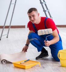 Wall Mural - Contractor worker preparing for wallpaper decoration