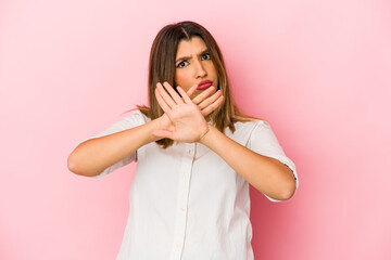 Young indian woman isolated on pink background doing a denial gesture