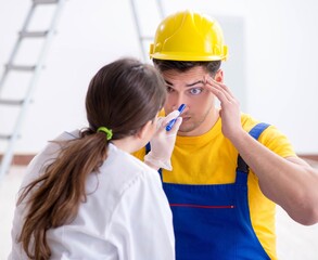 Wall Mural - Doctor helping injured worker at construction site