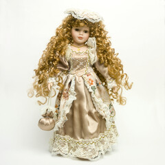 Poster - Vintage doll with a beautiful dress and golden tresses on the white background