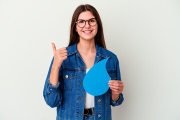 Young caucasian woman celebrating world water day isolated on pink background smiling and pointing aside, showing something at blank space.