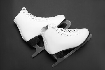 Wall Mural - Pair of skates on black background, flat lay